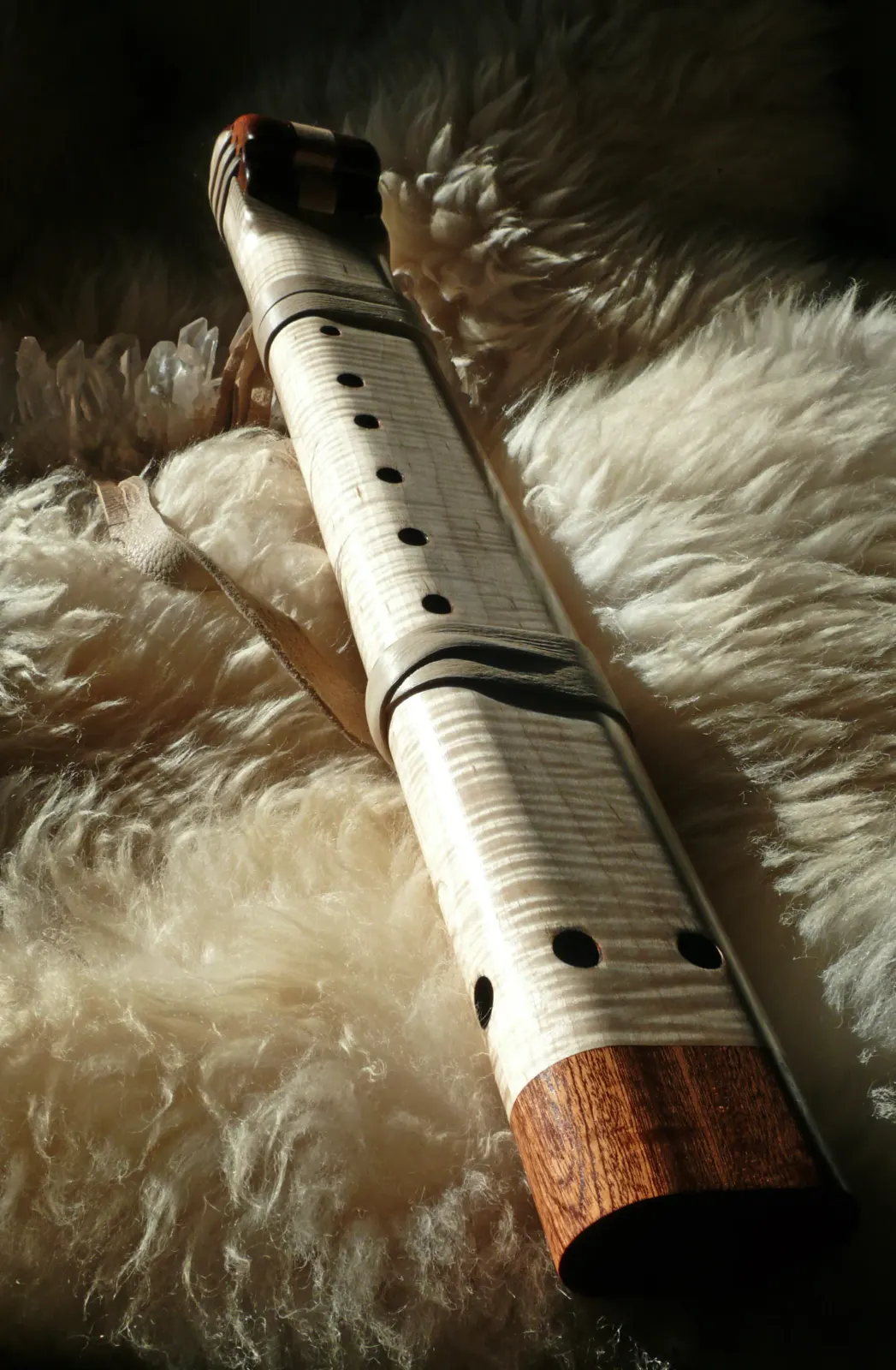 Striking curly maple wood grain on a hand-carved flute body